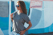 © Alena Ozerova - Model wearing plain tshirt and sunglasses posing over street wall