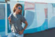© Alena Ozerova - Model wearing plain tshirt and sunglasses posing over street wall