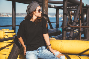 Wall Mural - Model wearing plain tshirt and sunglasses posing over street wall