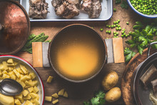 Pot With Meat Broth , Cooking Preparation For Potatoes Soup With Green Peas, Top View