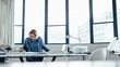 © Jacob Lund - Female designer working on blueprint in office