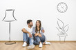© realstock1 - The man and woman sit near the wall with illustrations