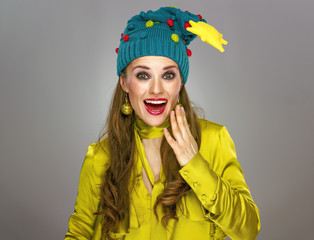 surprised woman in Christmas hat isolated on grey background