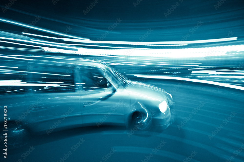Minivan driving through the streets in motion blur lights - obrazy, fototapety, plakaty 