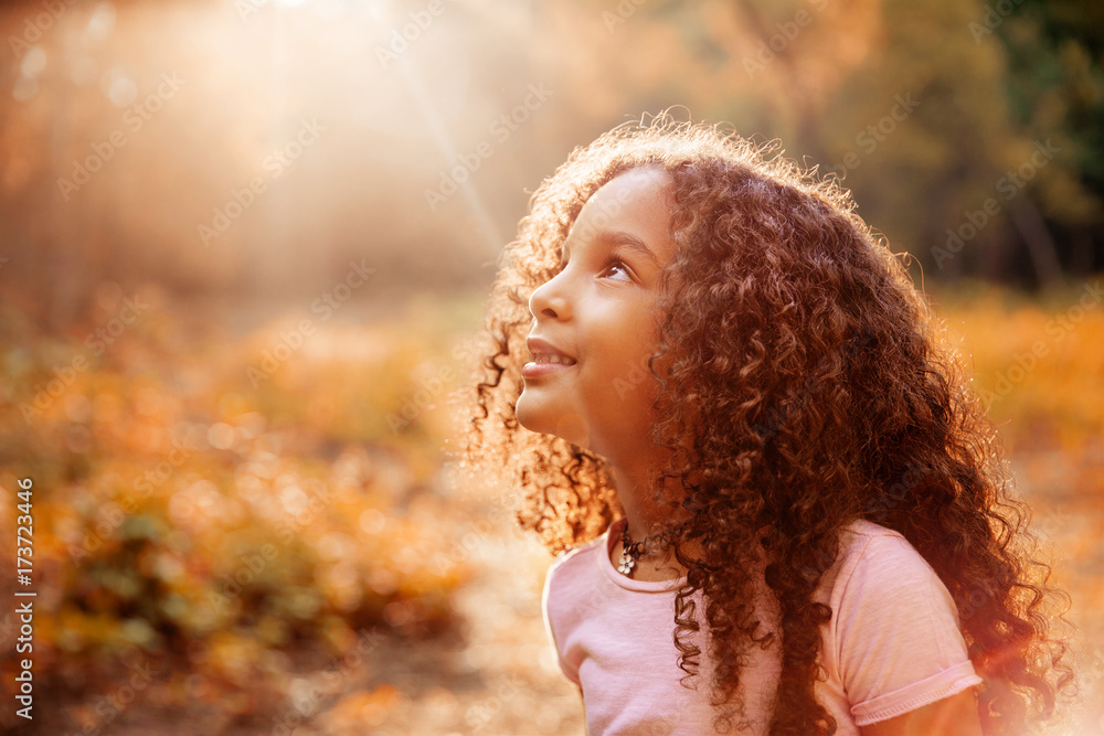 Afro american cute little girl with curly hair receives miracle sun ...