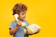 © kegfire - Boy talking obsolete phone