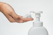 © morkdam - Close up Woman hand take cleaner foam from Pure white plastic pump bottle