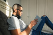 © BONNINSTUDIO/Stocksy - Side view of man reading a book on bed