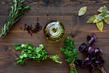 Poster - Bottle with organic oil with herbs ingredients on wooden background top view