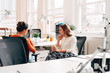 © Aila Images/Stocksy - Businesswomen catching up at work