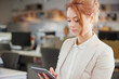© Aila Images/Stocksy - Businesswoman using digital tablet touchscreen in trendy office