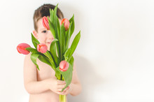 Little Boy Holding A Bunch Of Tulips