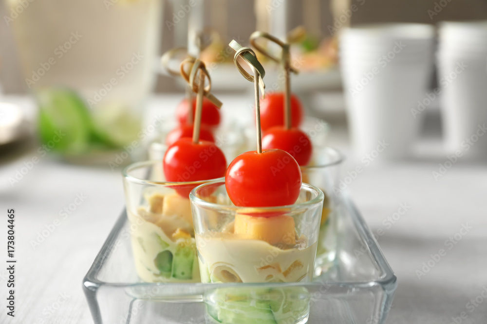 Delicious appetizers for baby shower in glass dish on table