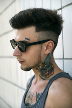 Side View Of Tattooed Man In Sunglasses