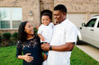 © Kristen Curette Photography LLC/Stocksy - A beautiful family of three outdoors / infront of their home.