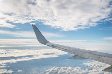 Canvas Print - The view from the plane. Blue sky with clouds on a Sunny day.