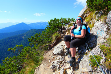 overweight woman enjoying life. nordic walking in alpine landscape. healthy lifestyle and weight los