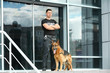 © Africa Studio - Security guard with dog near building