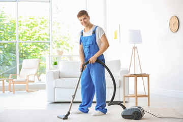 Wall Mural - Man cleaning white carpet with vacuum in living room