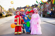 © famveldman - Kids and parents on Halloween trick or treat