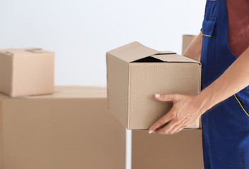 Wall Mural - Delivery man holding box, closeup