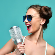 Fashion Brunette Woman Singing With Big Hair Brush In Modern Aviator Sunglasses