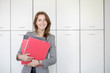 © Maxim - woman with red folder for documents on white background