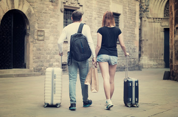 Positive man and woman going the historic city center