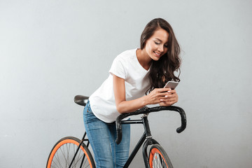 Wall Mural - Happy young caucasian lady sitting on bicycle