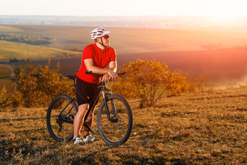 Wall Mural - Traveler with backpack Riding the Bike on the Beautiful autumn