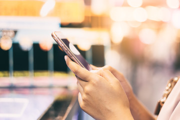 Closeup young urban woman using mobile smartphone connect online social