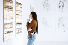 Young Woman Observing Painting