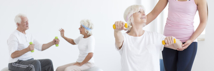 Wall Mural - Senior woman exercising with dumbbells