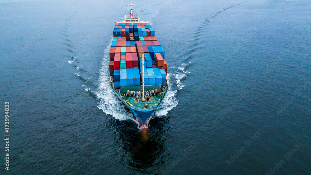 Aerial view from drone, container ship boat or cargo freight ship in sea water for import export and business logistic transport.