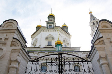 Dome of the church with two towers and closed iron gates