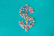 © Kathryn Swayze/Stocksy - The dollar symbol built from nonpareils