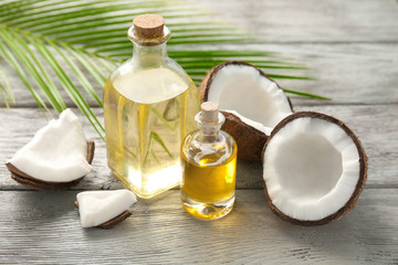 Poster - Bottles with fresh coconut oil on wooden table