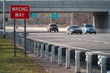 © Brandon Klein - Wrong Way caution safety sign posted along a major interstate highway facing the opposite direction of traffic to avoid car vehicle collision accidents