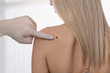 © dream@do - Doctor dermatologist examines birthmark of patient. Checking benign moles.