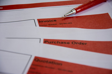 the red pencil put on the invoice red tab paper close up background