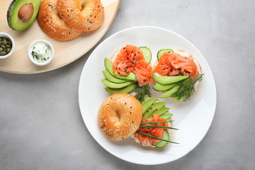 Canvas Print - Plate with delicious salmon bagels on table