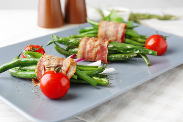 Plate with delicious bacon-wrapped green beans, closeup