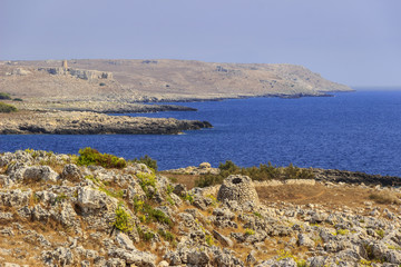 The most beautiful coasts of Italy: adriatic sea of Salento (Apulia). The Otranto-Santa Maria di Leuca Coast and Tricase Woods regional nature park: in the background Sant 'Emiliano tower and trullo.