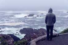 Lonely Man Standing In Front Of The Pacific Ocean And Looking At The Stormy Sea On Vancouver Island.