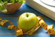 © freebird7977 - Green apple with weight scale and measuring tape for the healthy diet slimming . Diet and Healthy Concept