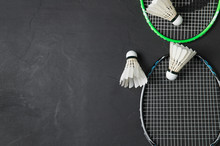 Shuttlecocks And Badminton Racket On Black Background.