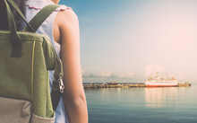 Girl With Backpack Waiting For A Cruise Ship At Sea Port.