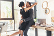Young couple embracing in office