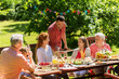 © Syda Productions - happy family having dinner or summer garden party