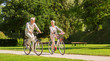 © Syda Productions - happy senior couple riding bicycles at summer park